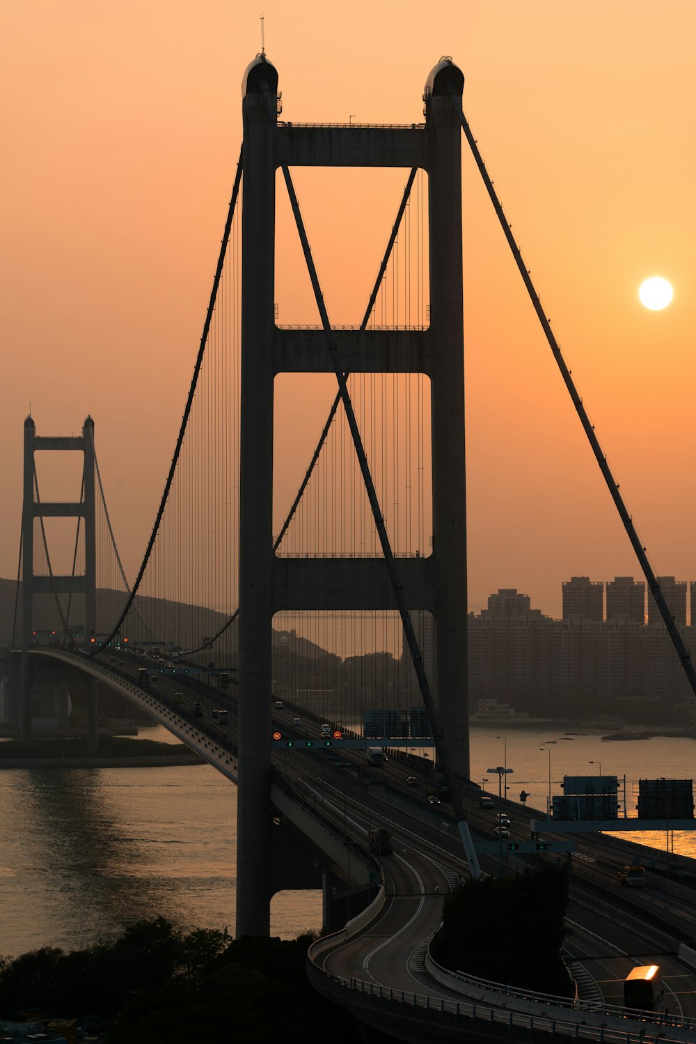 bridge over body of water during sunset