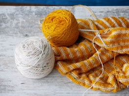 orange yarn on brown textile