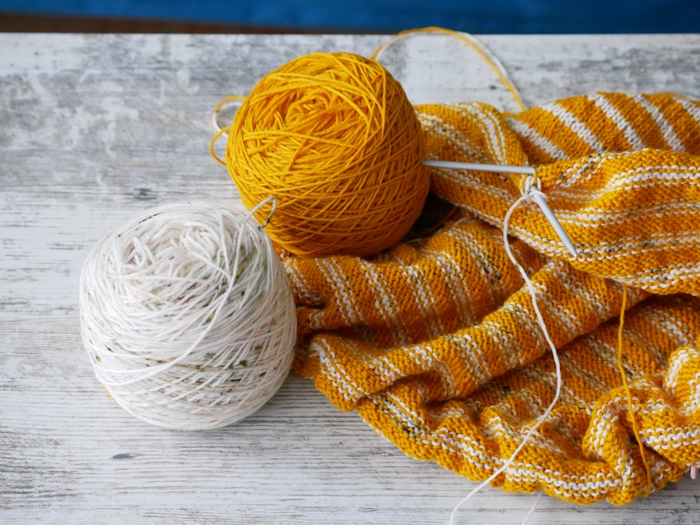 orange yarn on brown textile