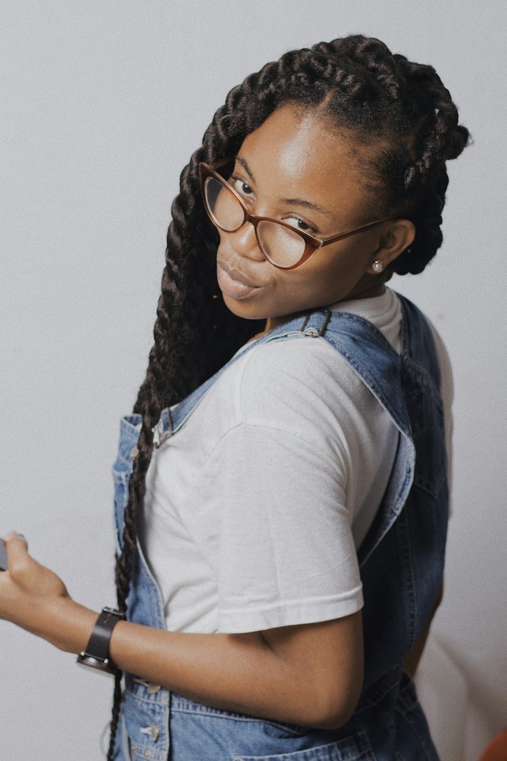 woman in blue denim vest and white shirt