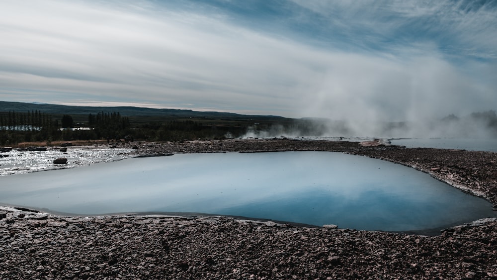 body of water under cloudy sky during daytime