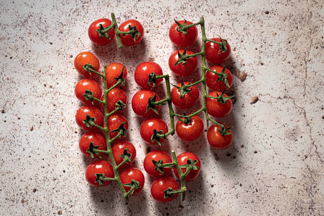 red cherries on gray surface