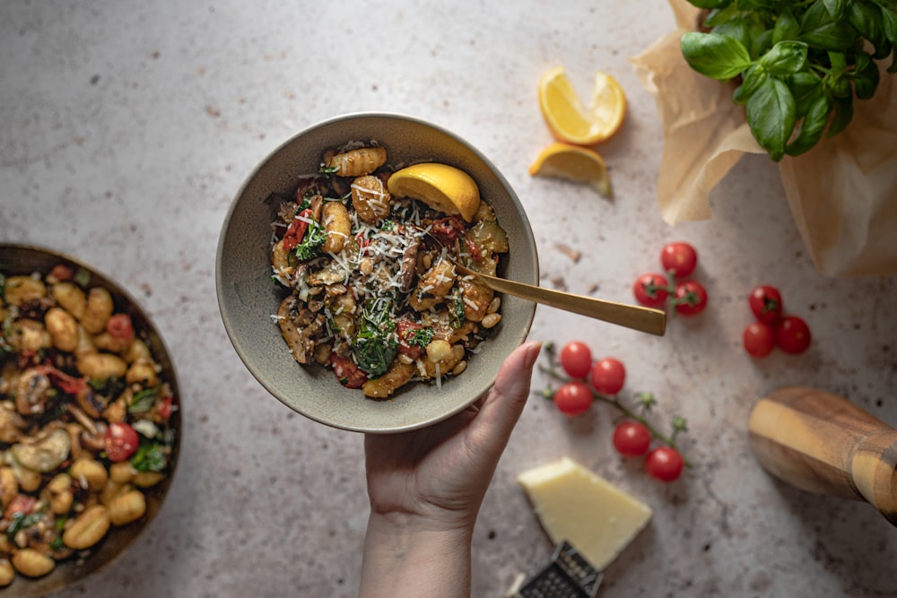 person holding bowl of food