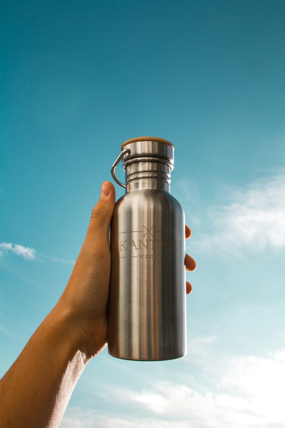 stainless steel vacuum flask on persons hand