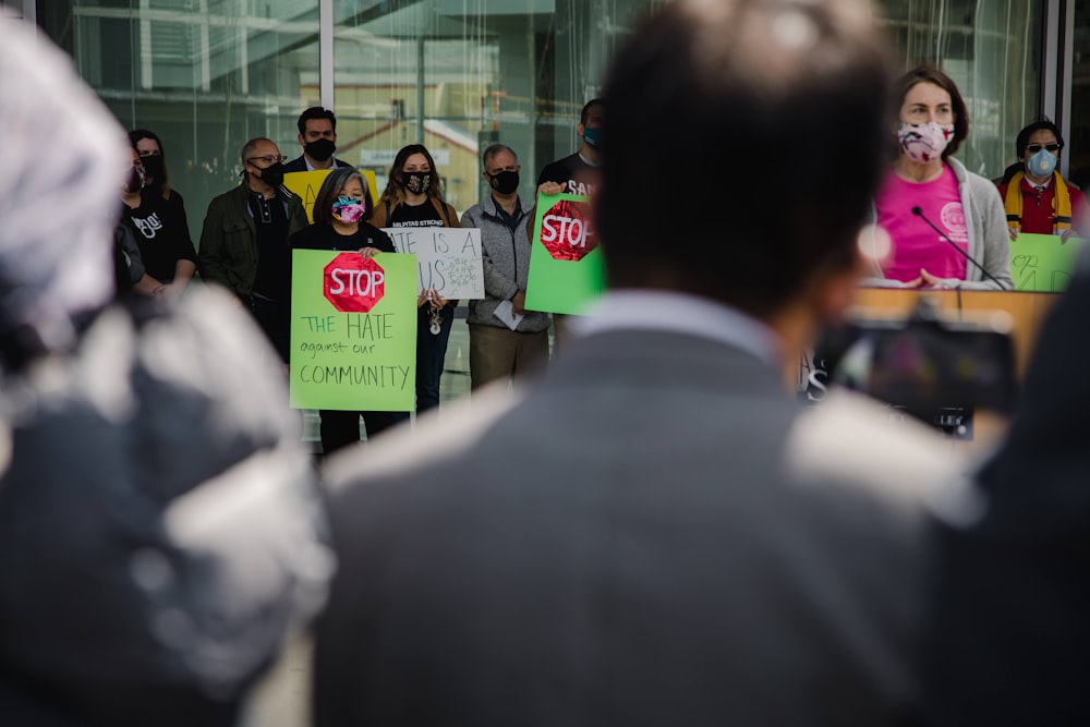 people standing in front of glass building during daytime