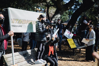 An outdoor gathering with banners promoting civic participation.