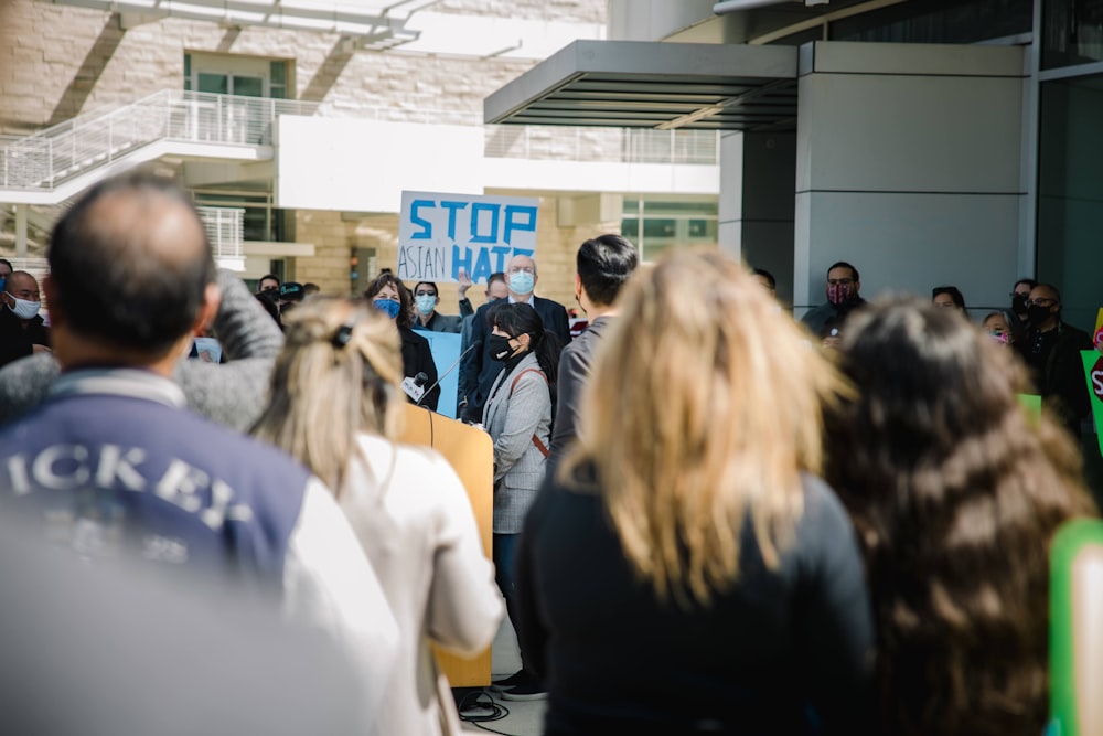 people standing in front of white building during daytime