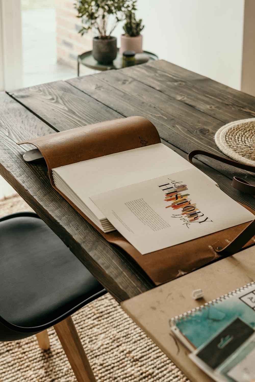 white book on black wooden table