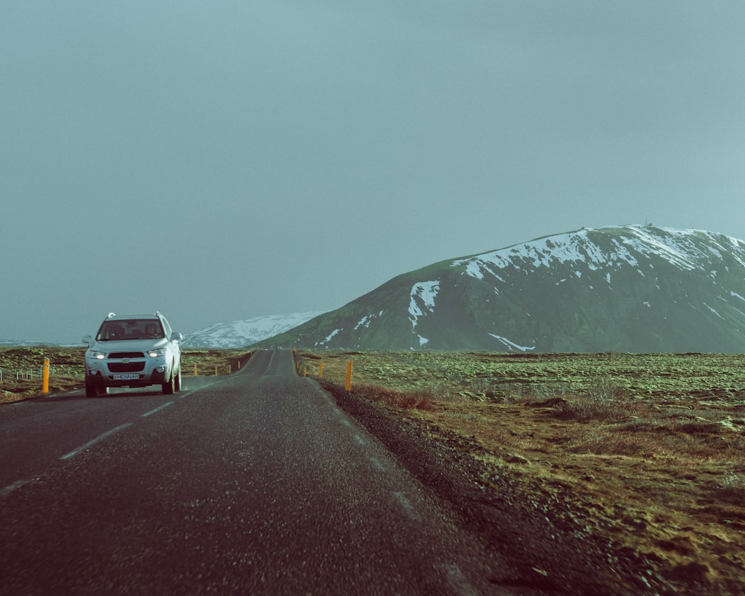 white suv on road near mountain during daytime