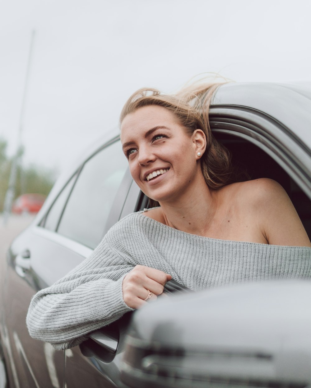 woman in white knit sweater smiling