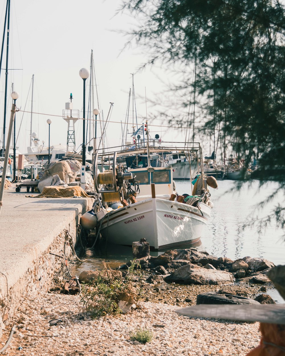 white and blue boat on body of water during daytime