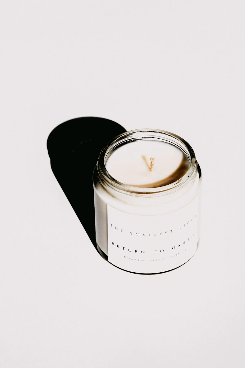 White candle in a clear glass container