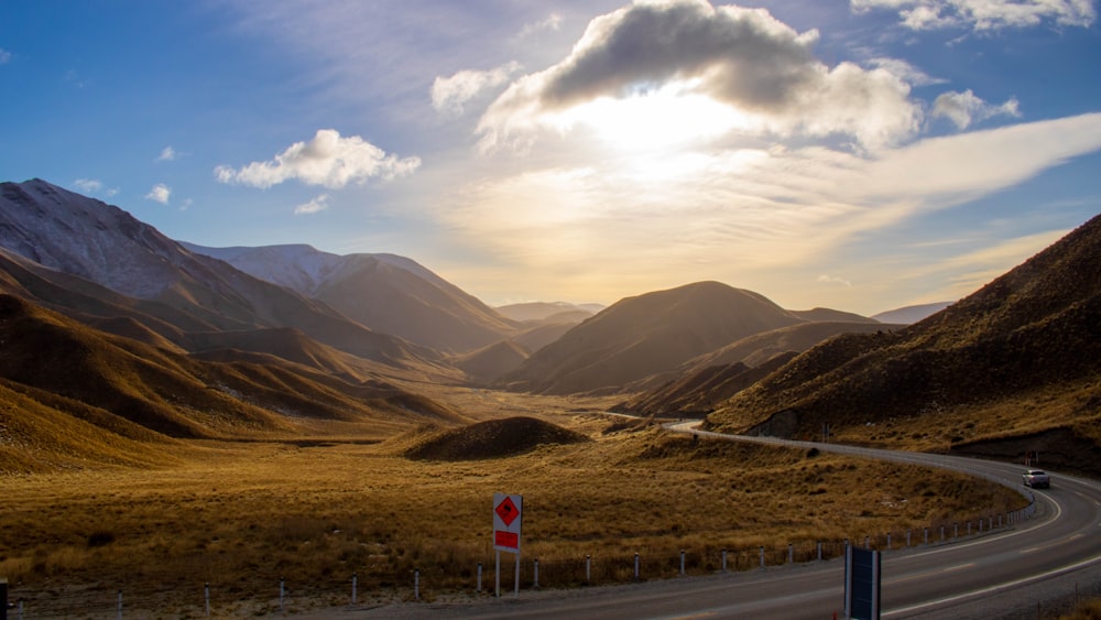 green and brown mountains under white clouds during daytime