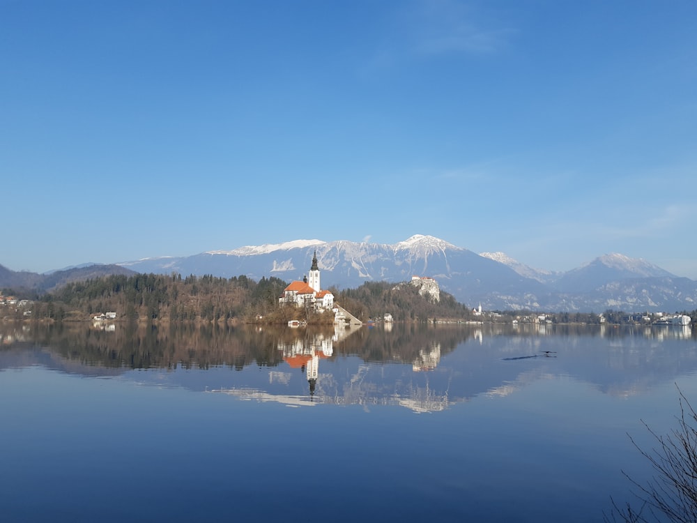 body of water near mountain under blue sky during daytime