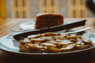 Close-up of a homemade mango pie slice on a rustic plate with a fork