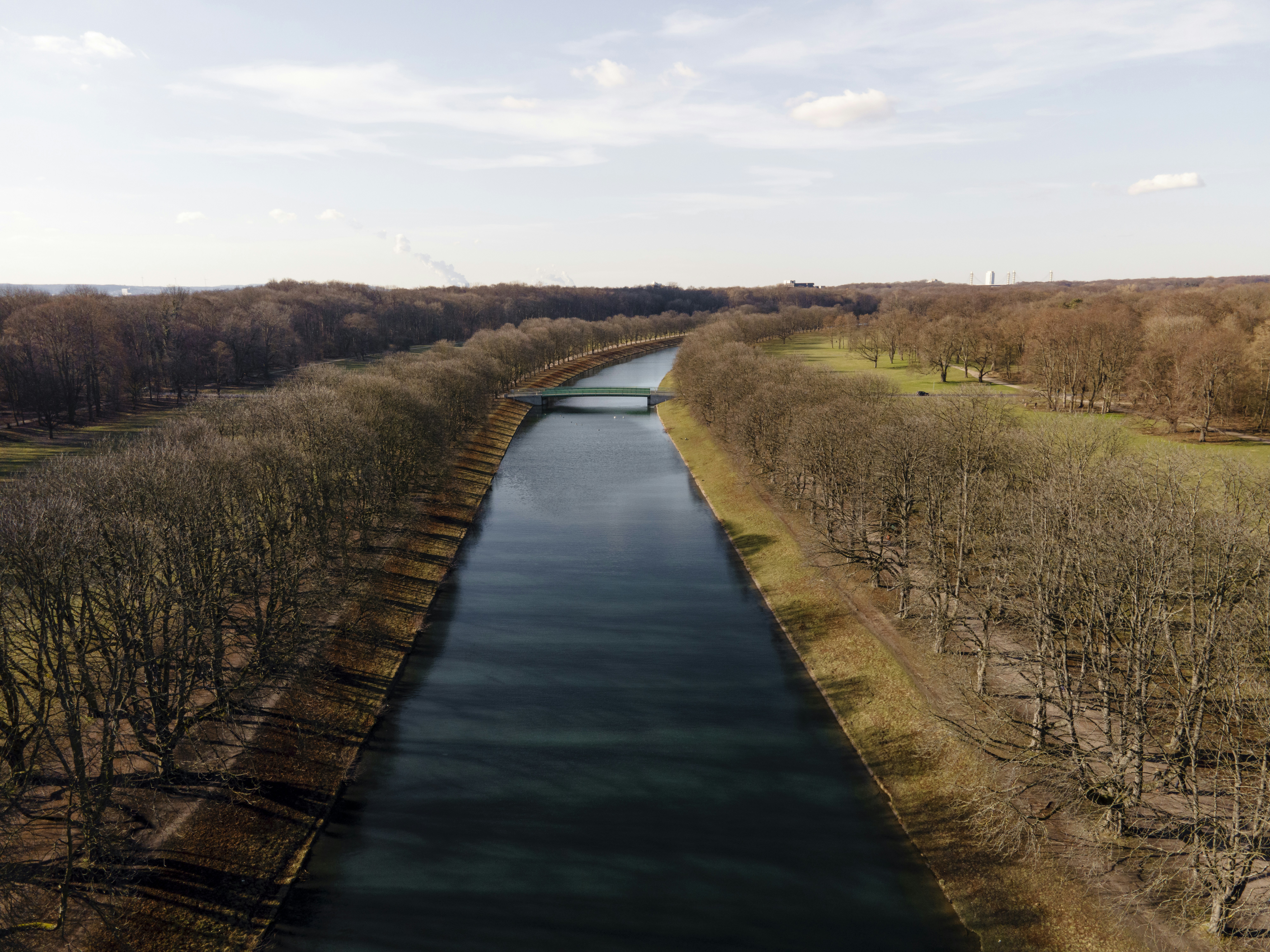 river between green grass field during daytime, 