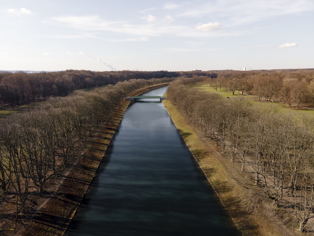 river between green grass field during daytime