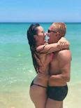A joyful couple celebrating their honeymoon on a tropical island.