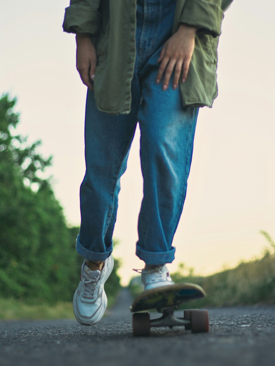 person in blue denim jeans and white sneakers