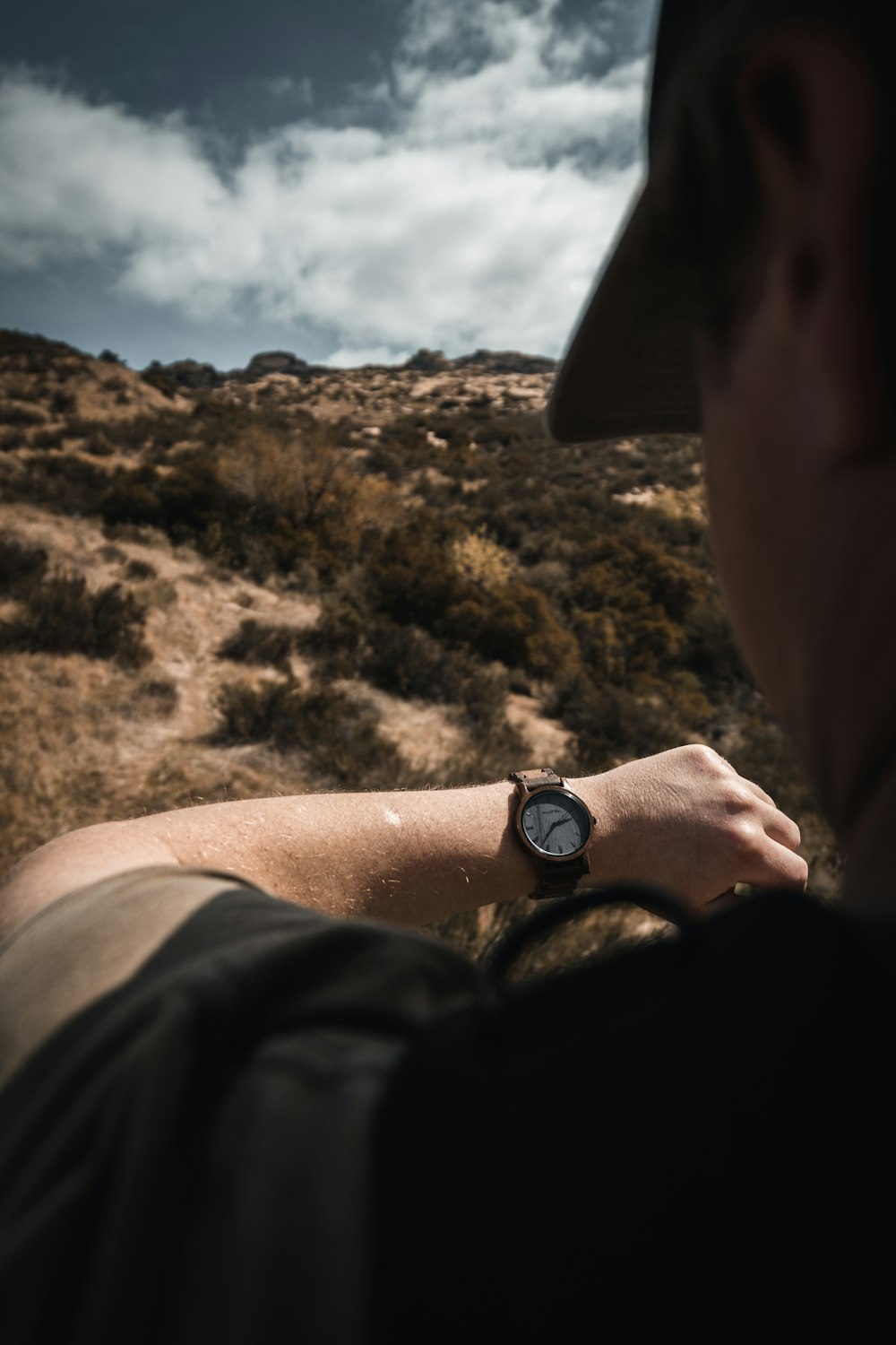 person wearing black round analog watch