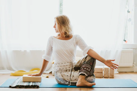 girl in white long sleeve shirt and blue pants sitting on white floor