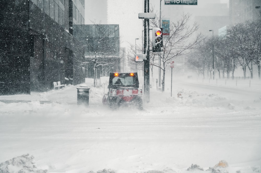 black car on snow covered road during daytime