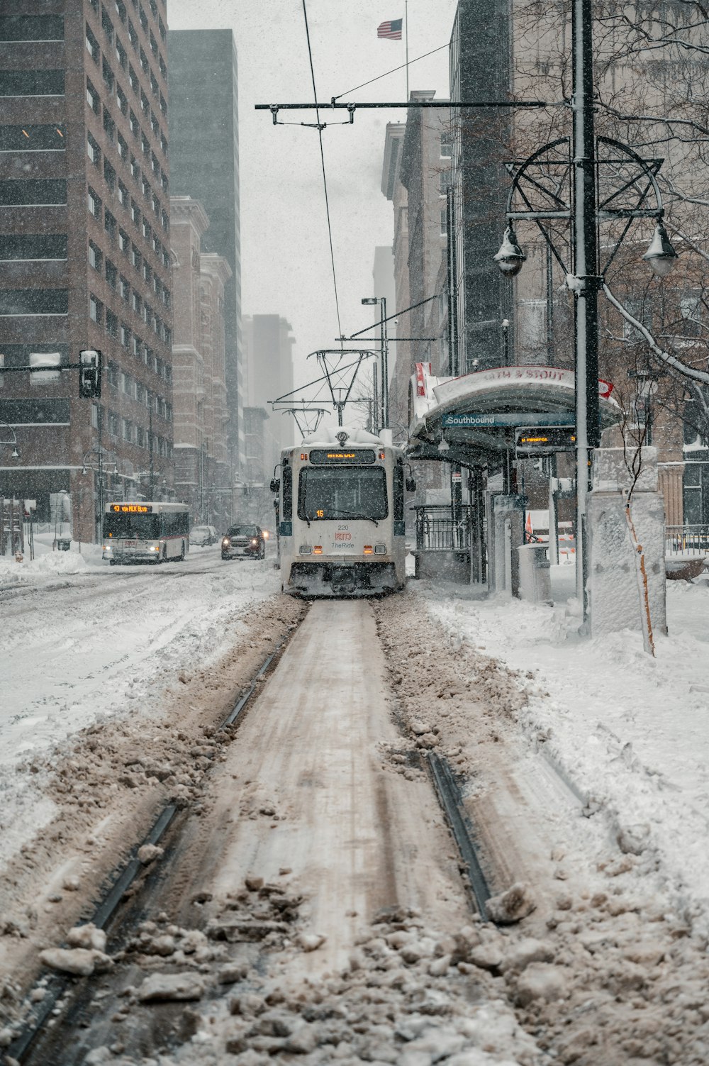 yellow and white train on rail tracks during daytime