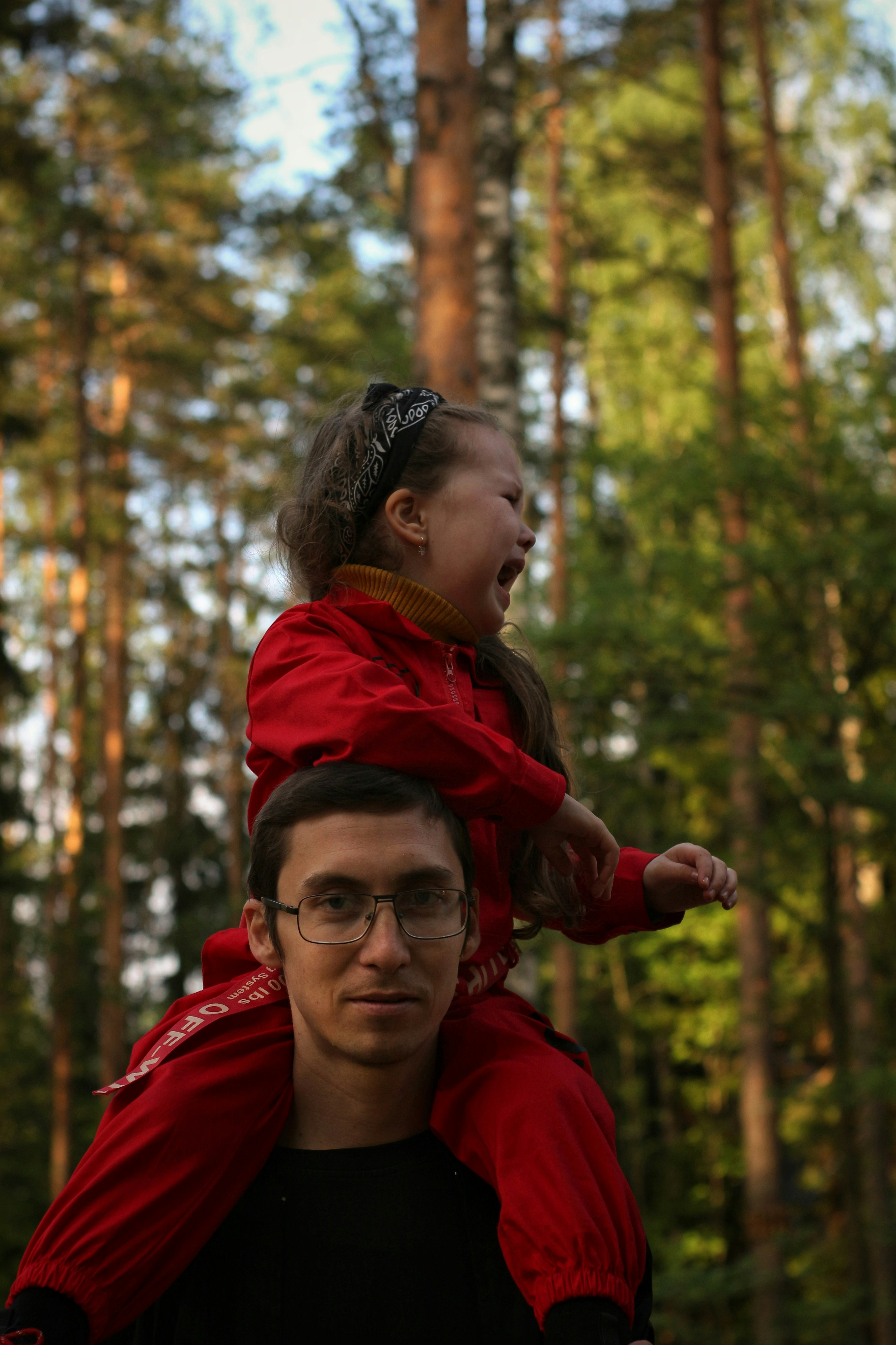 woman in red jacket wearing eyeglasses