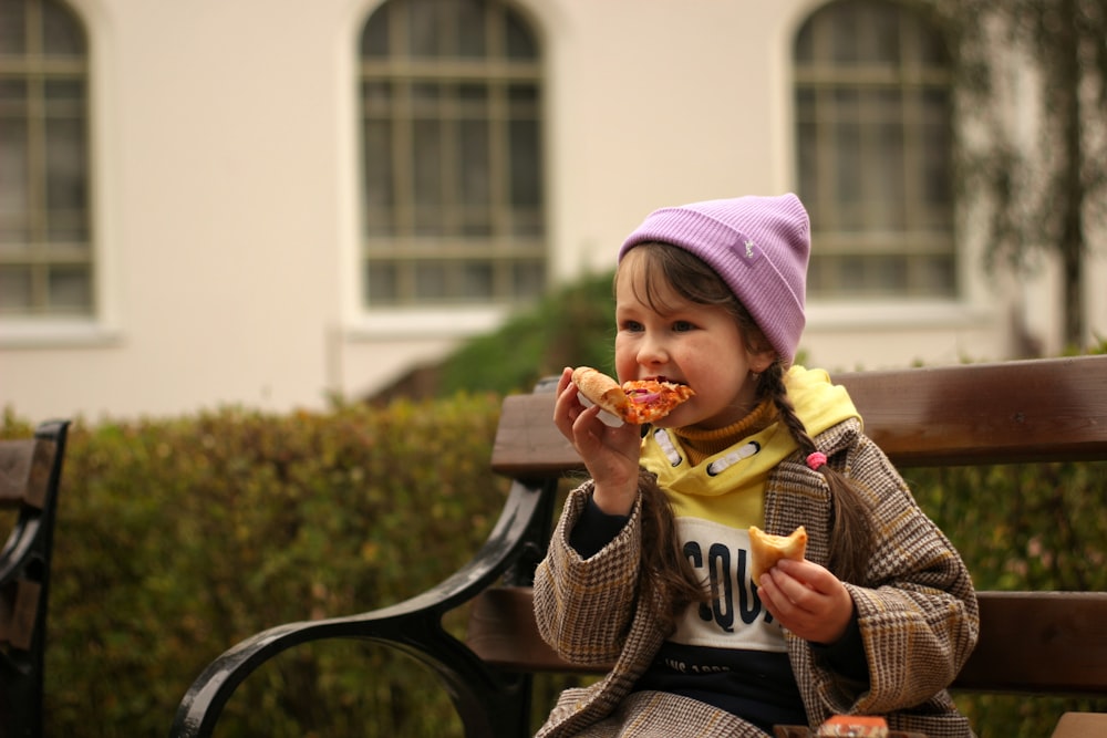 girl in pink knit cap eating ice cream