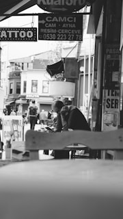 An urban café scene with a person reading stock market updates on a tablet