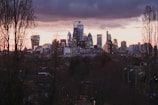 A city skyline featuring contemporary buildings at sunset.