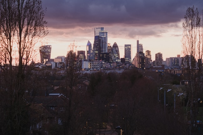 A city skyline featuring contemporary buildings at sunset.