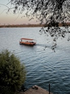 red boat on body of water during daytime