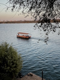 red boat on body of water during daytime