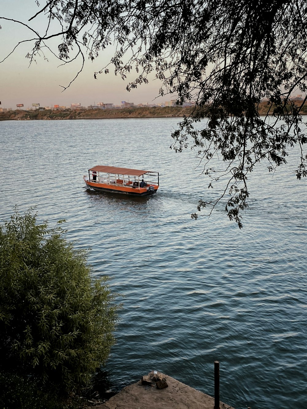 red boat on body of water during daytime