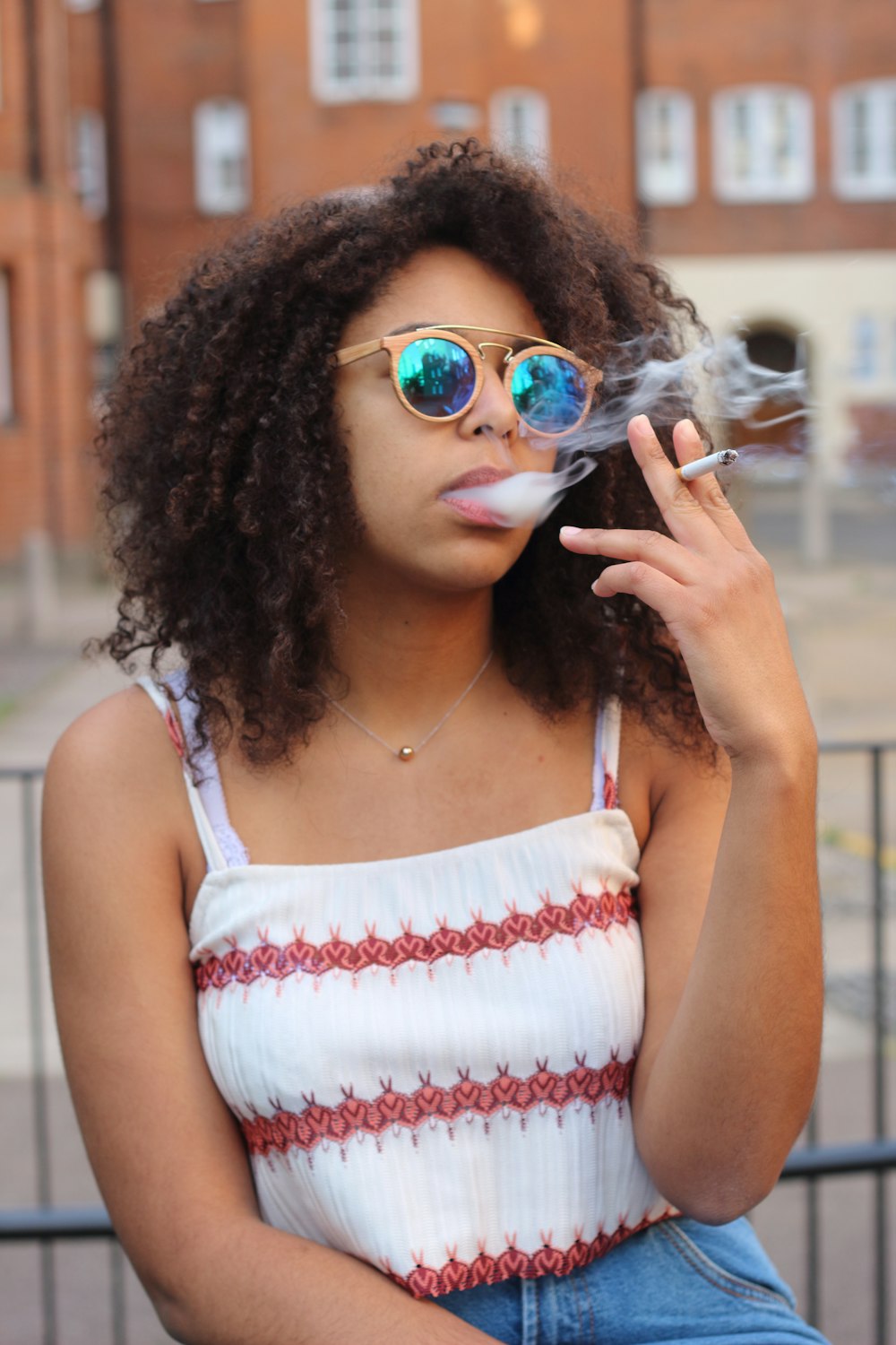 woman in white and red tank top wearing aviator sunglasses photo – Free  Smoking girl Image on Unsplash