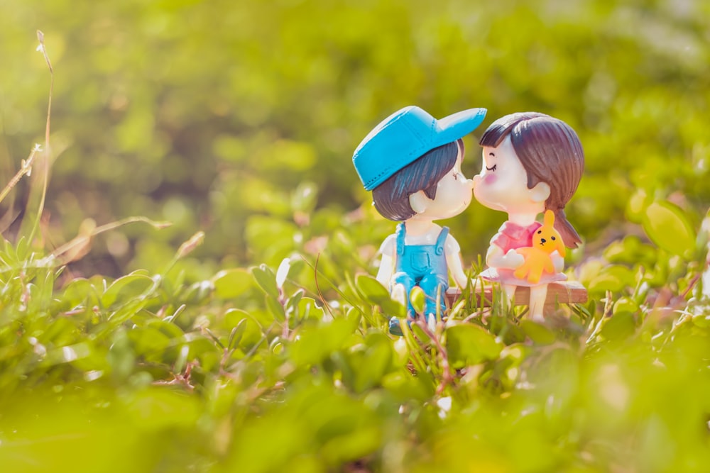 girl in blue hat on yellow flower field during daytime