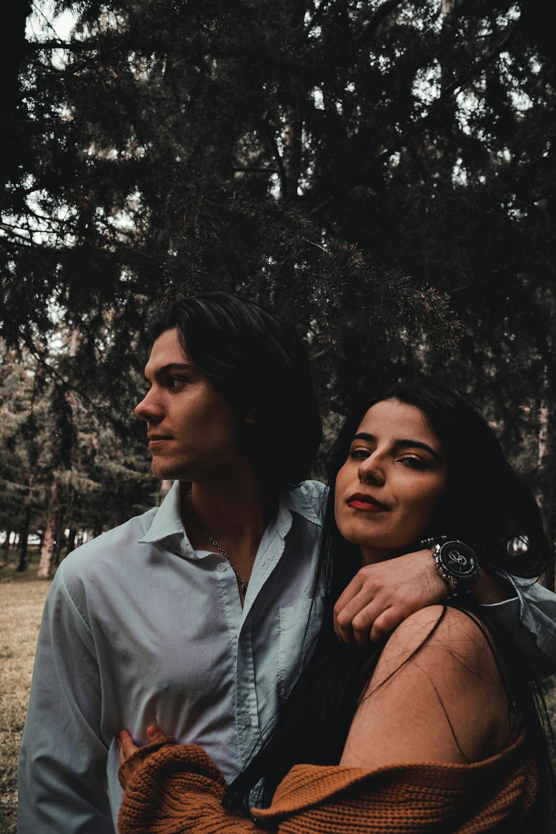 man in white button up shirt beside woman in black tank top