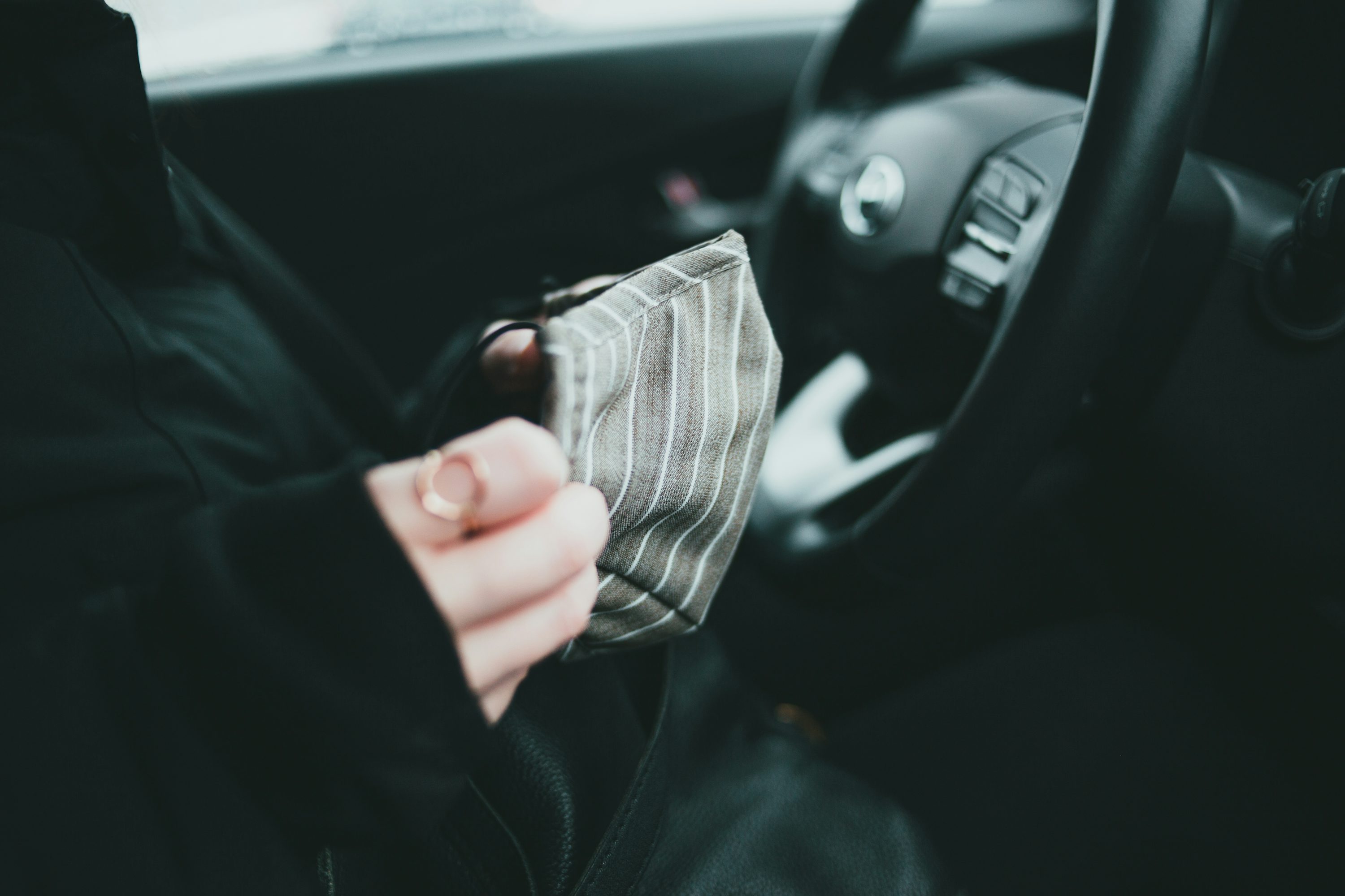 person holding white and black striped textile