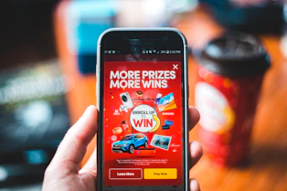 red and black smartphone showing game application