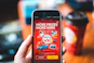 red and black smartphone showing game application