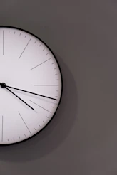 white analog wall clock at 11 00