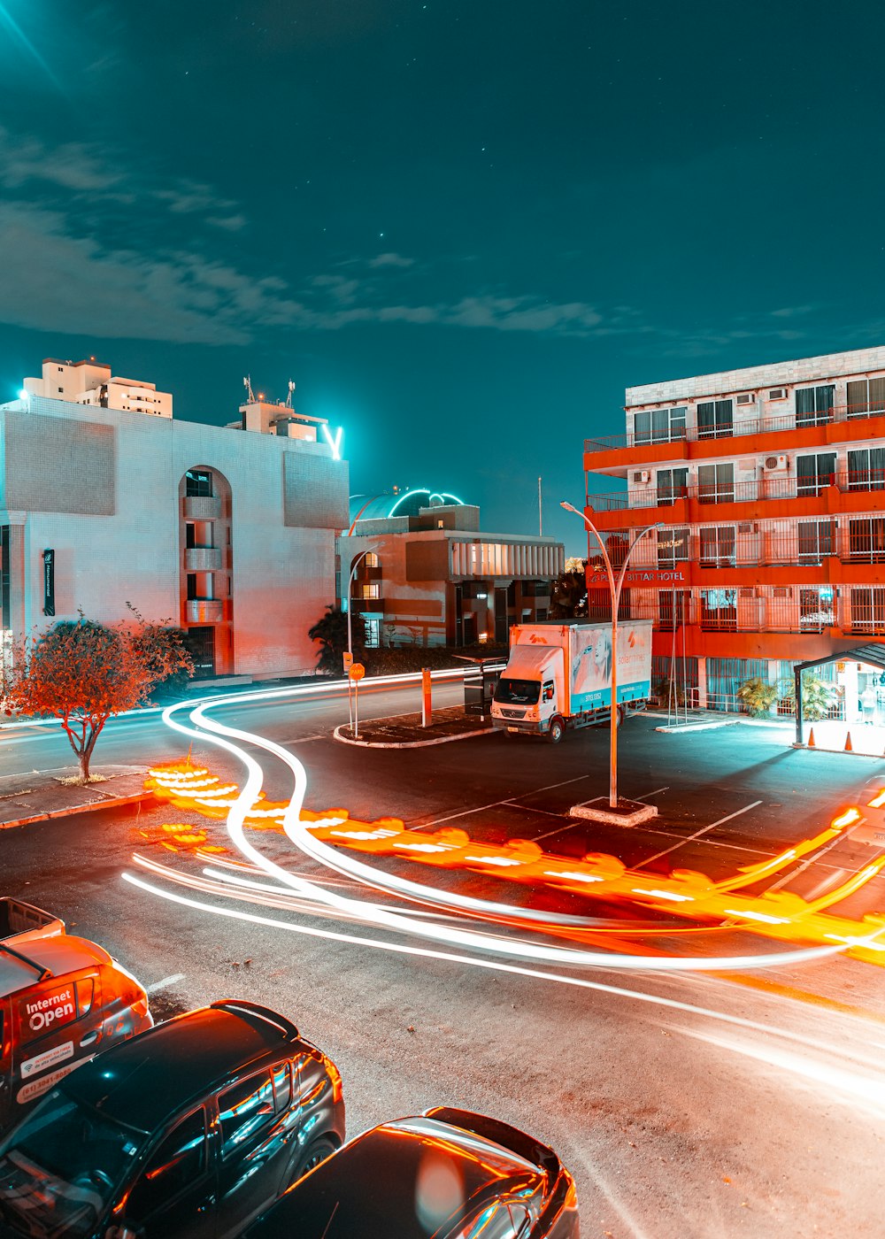 cars on road near brown concrete building during night time