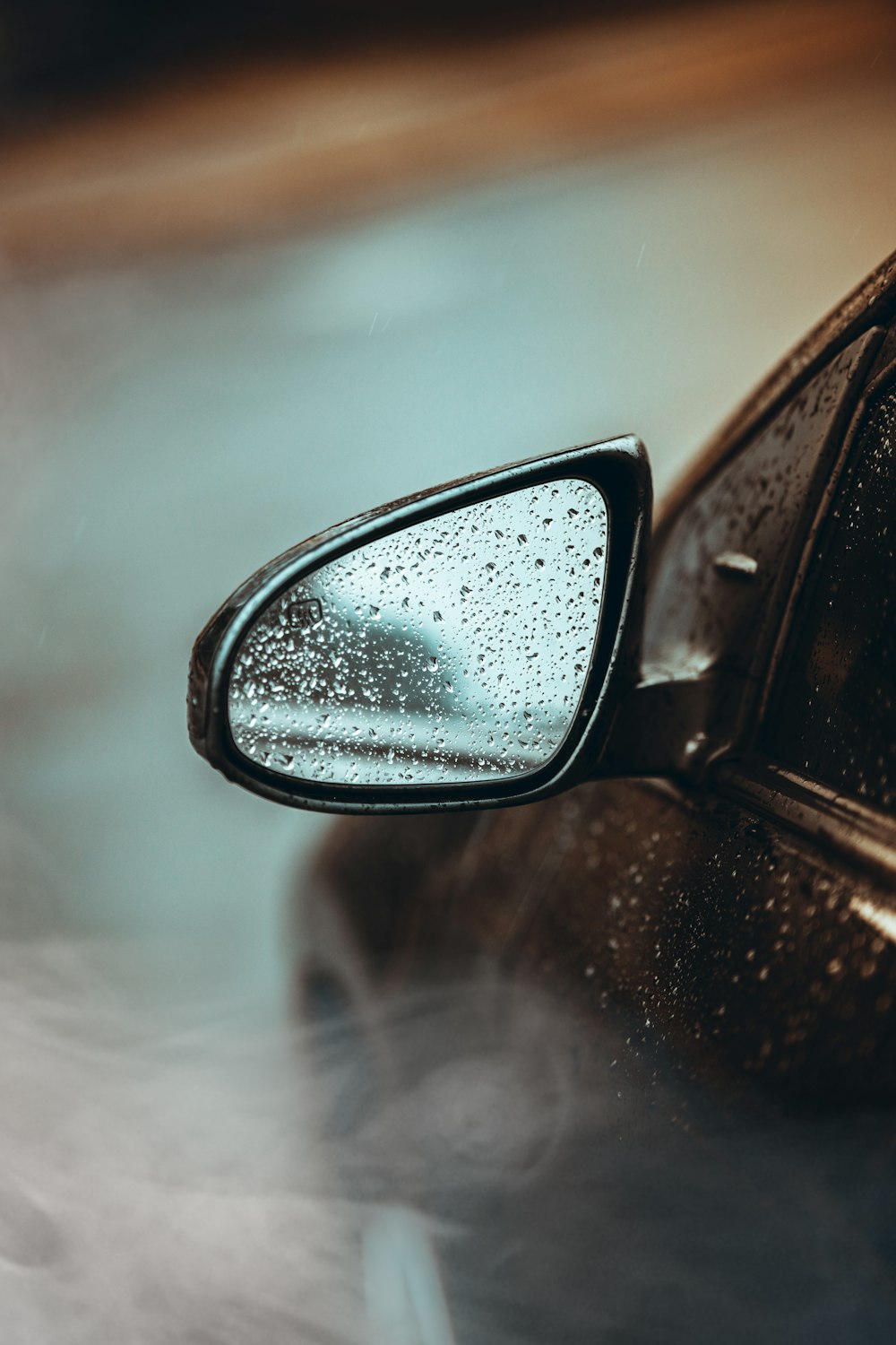 car side mirror with water droplets