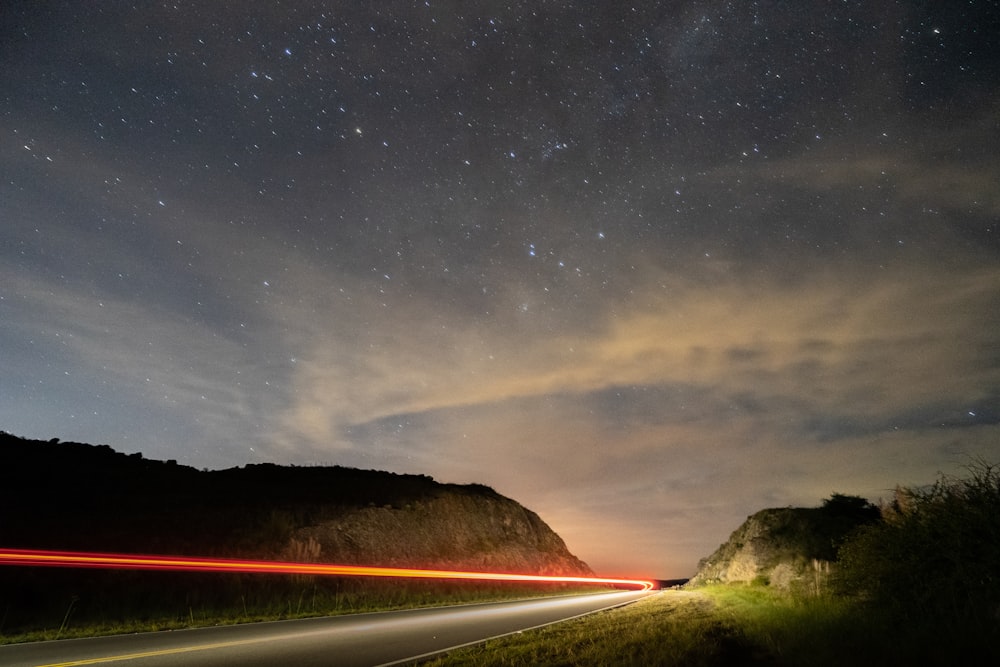 body of water near mountain under starry night