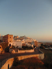 A panoramic view of Cunziria's restored stone houses bathed in warm sunset light.