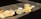 A variety of dishes is spread out on a concrete surface in bright sunlight. The meal includes large crisp papadums, slices of a loaf cake, possibly layered with filling, and what appears to be omelet or scrambled eggs served on oval plates. Small bowls of dipping sauce accompany the dishes.