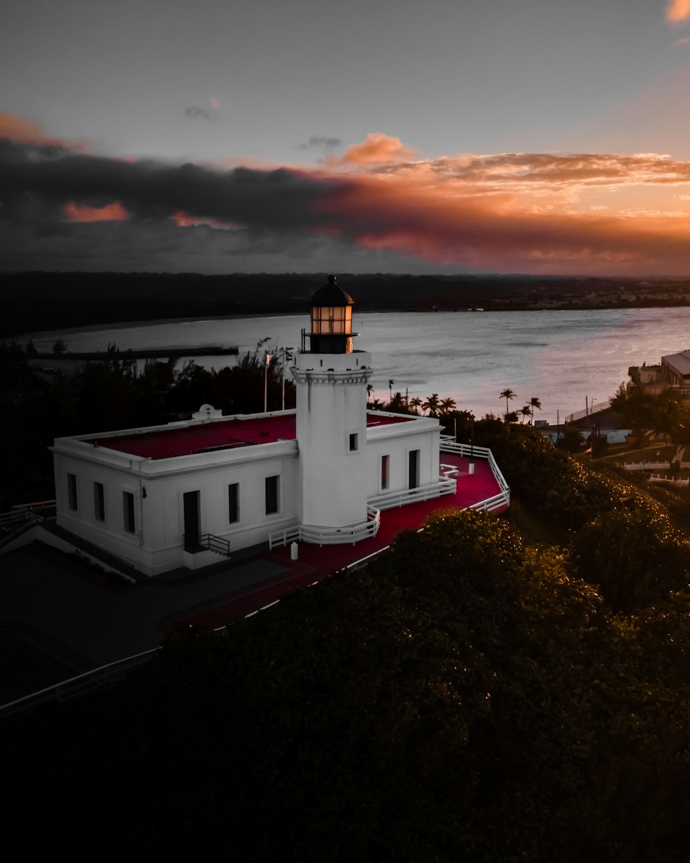 white concrete building near body of water during sunset