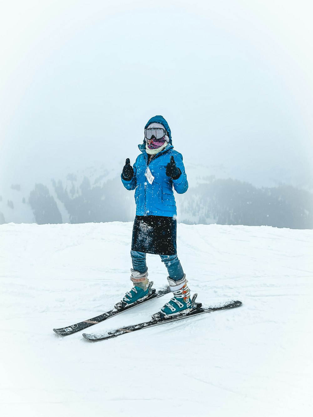 person in blue jacket and blue pants riding on snowboard