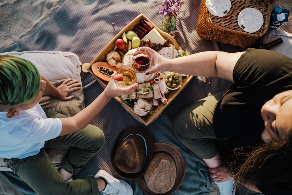 person holding brown wooden tray with food